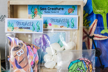 Load image into Gallery viewer, Ocean Adventure Seashell ABC Cards, Sea Creature Number Cards 1-12, Seashell counters and place holders, clear spinner and personalized gems for Ocean Adventure Name activity.