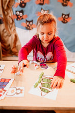 Load image into Gallery viewer, Little Girl Measuring Winter Pictures with Penguin Math Counters.