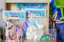 Load image into Gallery viewer, Ocean Adventure Seashell ABC Cards, Sea Creature Number Cards 1-12, Seashell counters and place holders, clear spinner and personalized gems for Ocean Adventure Name activity. 
