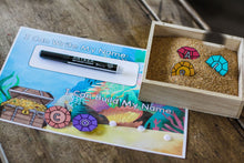 Load image into Gallery viewer, Ocean Explorer Personalized Name Mat with Gemstone Letters for name practice. This little learners name letters are placed in the included writing tray with sand filler.
