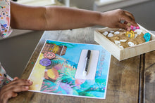 Load image into Gallery viewer, Preschooler pulling her gemstone letters from the sand writing tray for her personalized name activity. 

